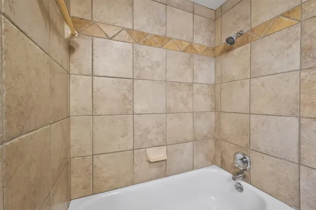 a bathroom with a bathtub and shower