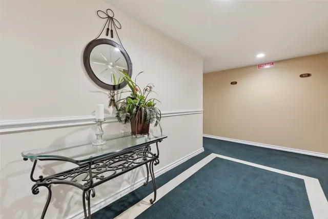a dining room with furniture and a mirror