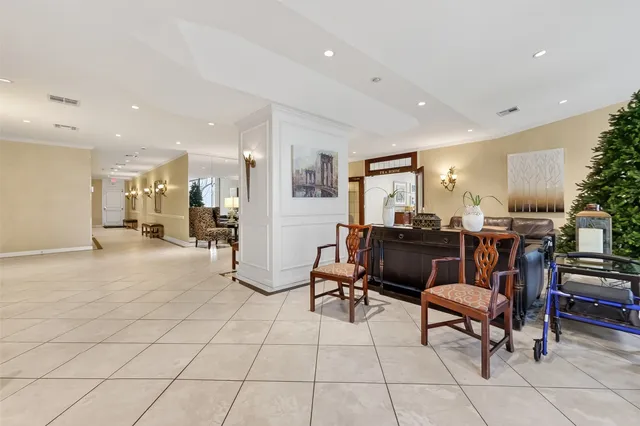 a living room with fireplace furniture and a large window