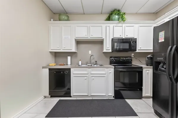 a front view of a house with garden and trees