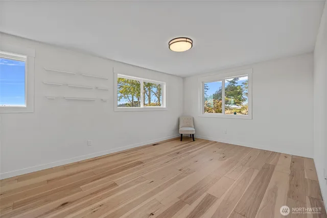 a bathroom with a granite countertop sink a toilet and a mirror