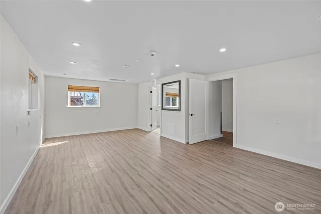 a bath room with a sink a toilet and shower