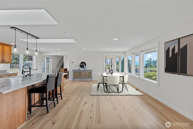 a dining room with furniture and wooden floor