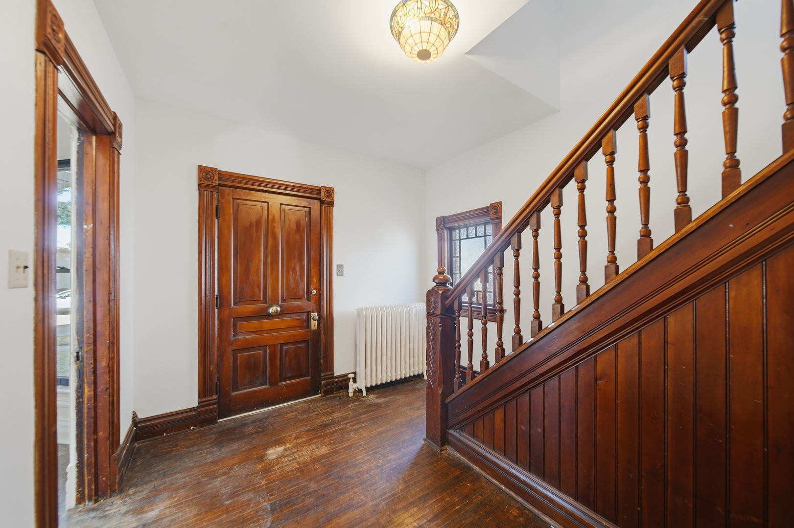 1102 West 3rd Street Dixon, IL 61021 - Photo 13 of 32 a view of an entryway with hardwood floor and stairs