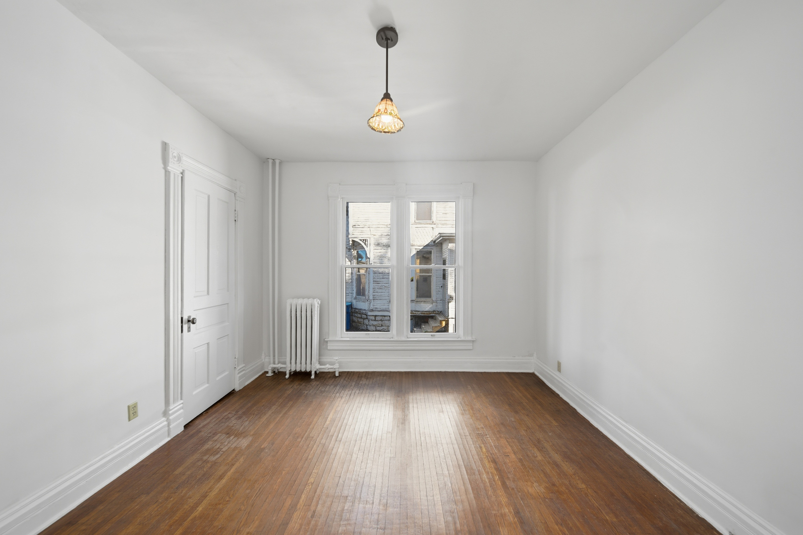 1102 West 3rd Street Dixon, IL 61021 - Photo 17 of 32 an empty room with wooden floor and windows