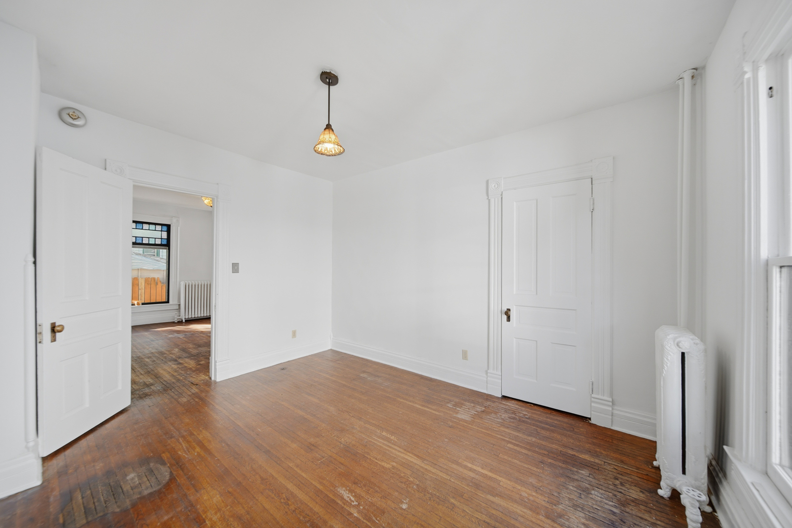 1102 West 3rd Street Dixon, IL 61021 - Photo 18 of 32 a view of an empty room with wooden floor and a window