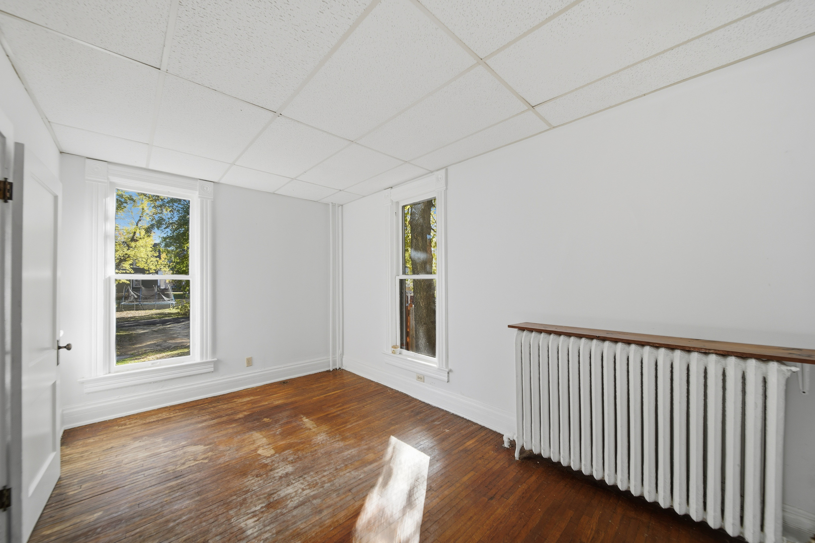 1102 West 3rd Street Dixon, IL 61021 - Photo 20 of 32 a view of a big room with wooden floor and windows