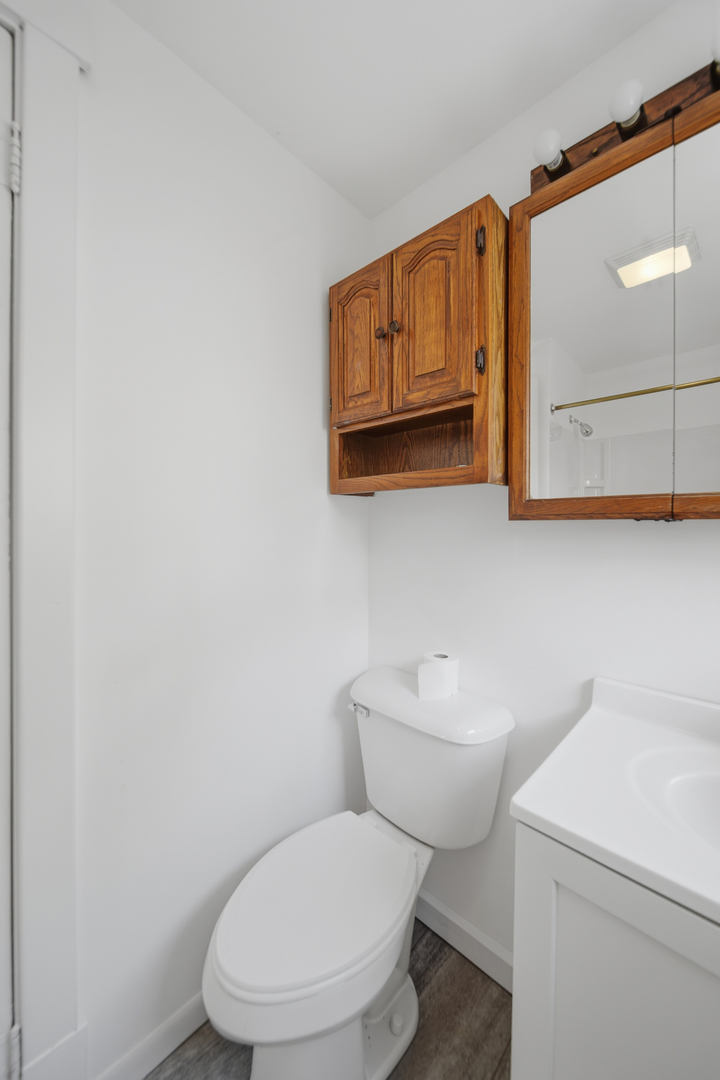 1102 West 3rd Street Dixon, IL 61021 - Photo 23 of 32 a white toilet sitting next to a bathroom sink