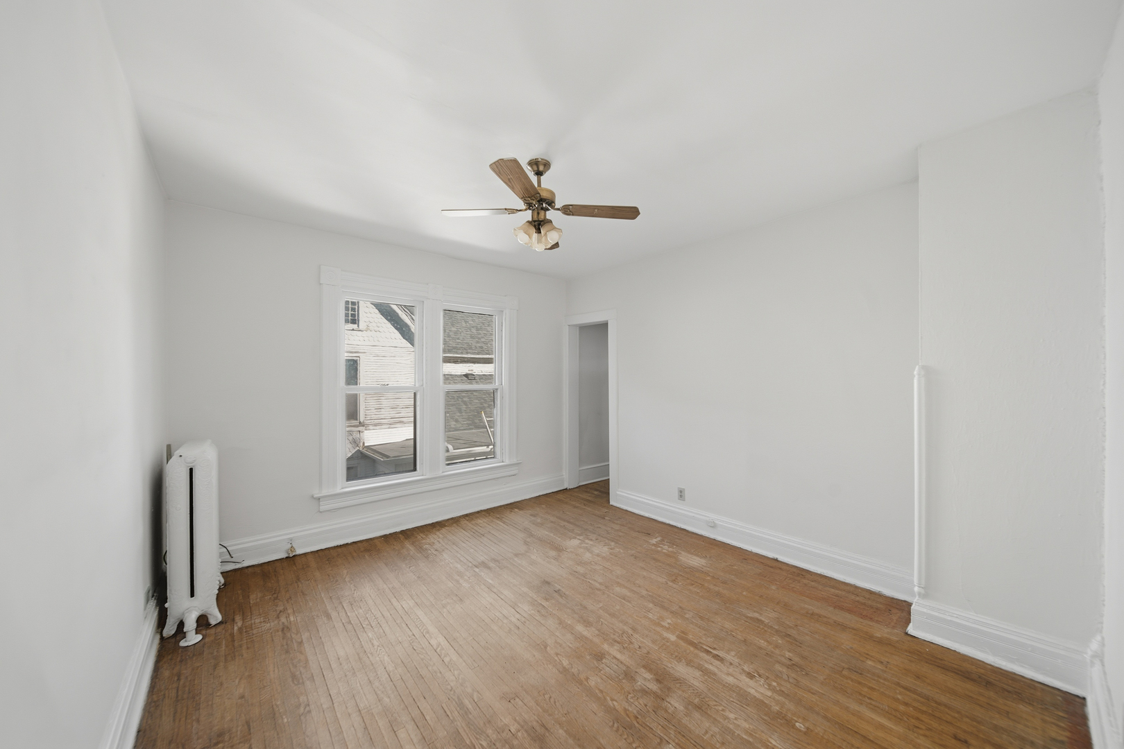 1102 West 3rd Street Dixon, IL 61021 - Photo 24 of 32 an empty room with wooden floor fan and windows