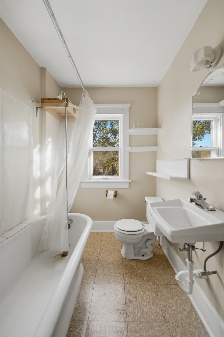 1102 West 3rd Street Dixon, IL 61021 - Photo 28 of 32 a bathroom with a sink toilet and shower