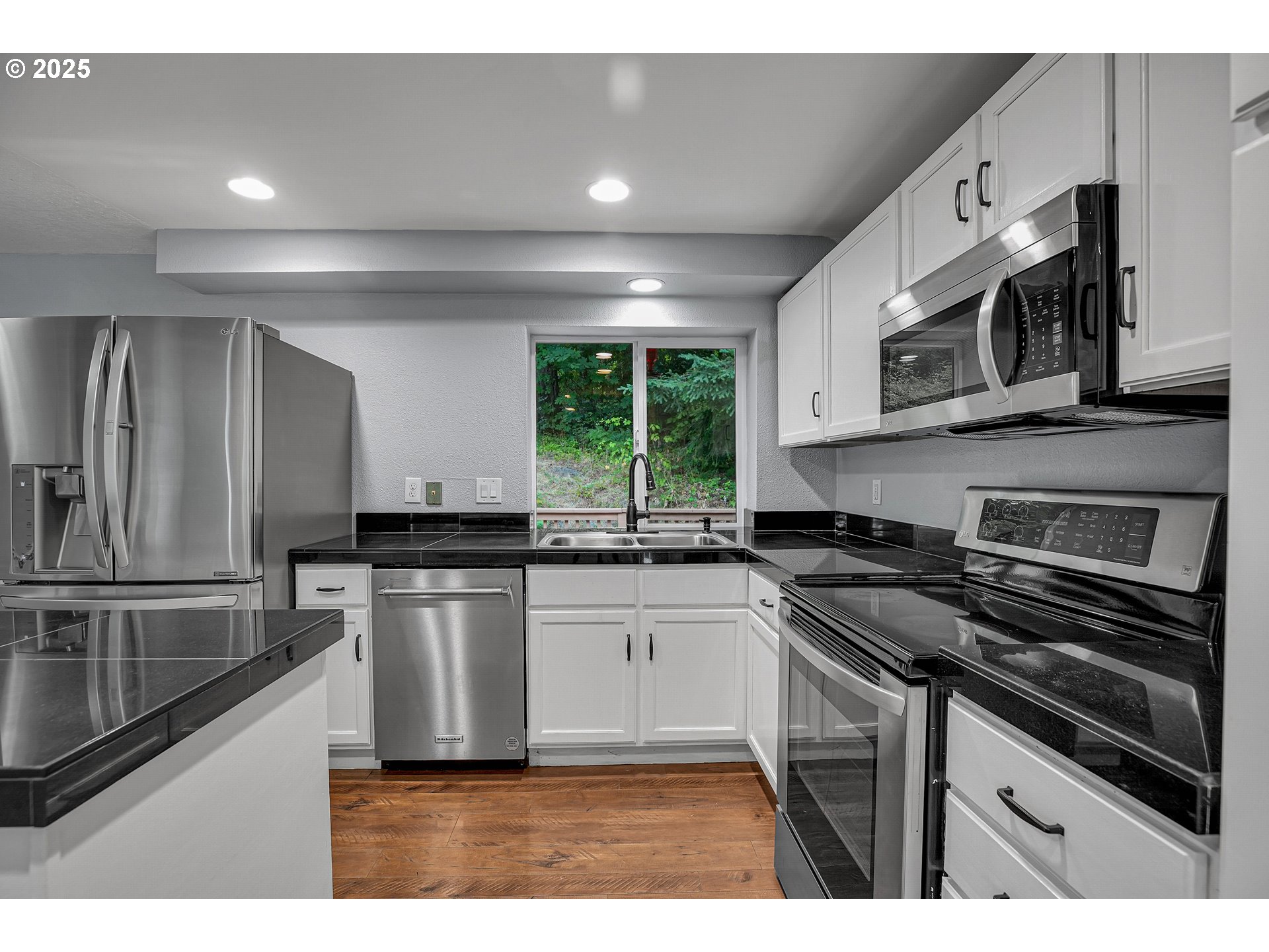 22486 South Redland Road Estacada, OR 97023 - Photo 11 of 46 a kitchen with stainless steel appliances granite countertop a stove a sink and a microwave