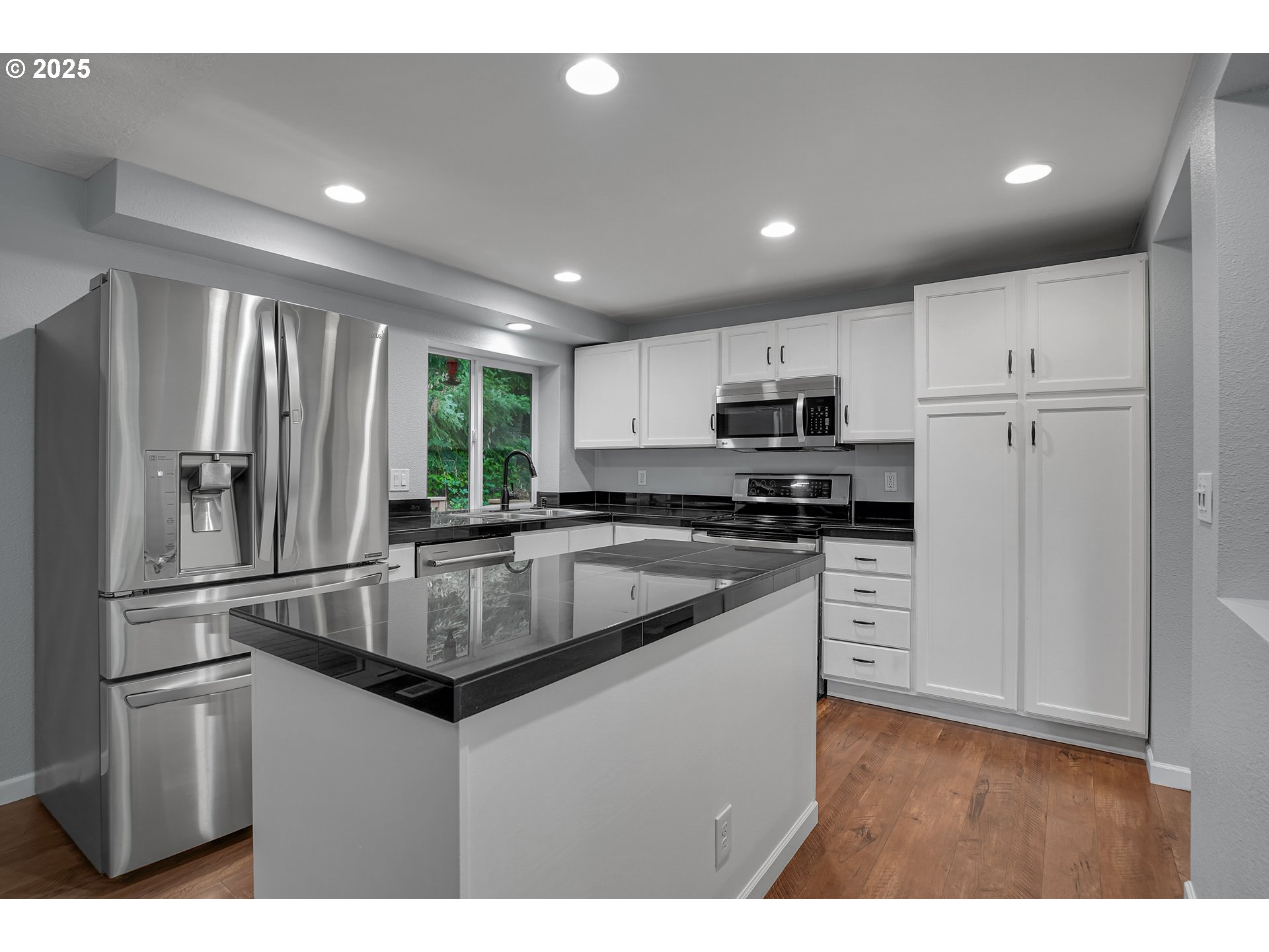 22486 South Redland Road Estacada, OR 97023 - Photo 12 of 46 a kitchen with kitchen island a counter top space stainless steel appliances and a window