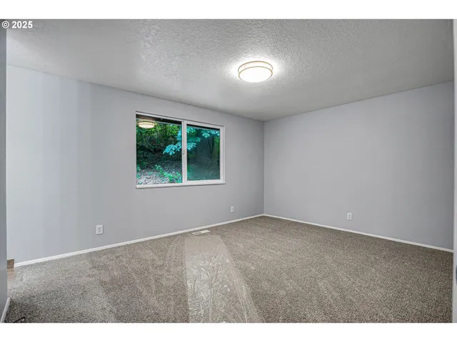 an empty room with wooden floor