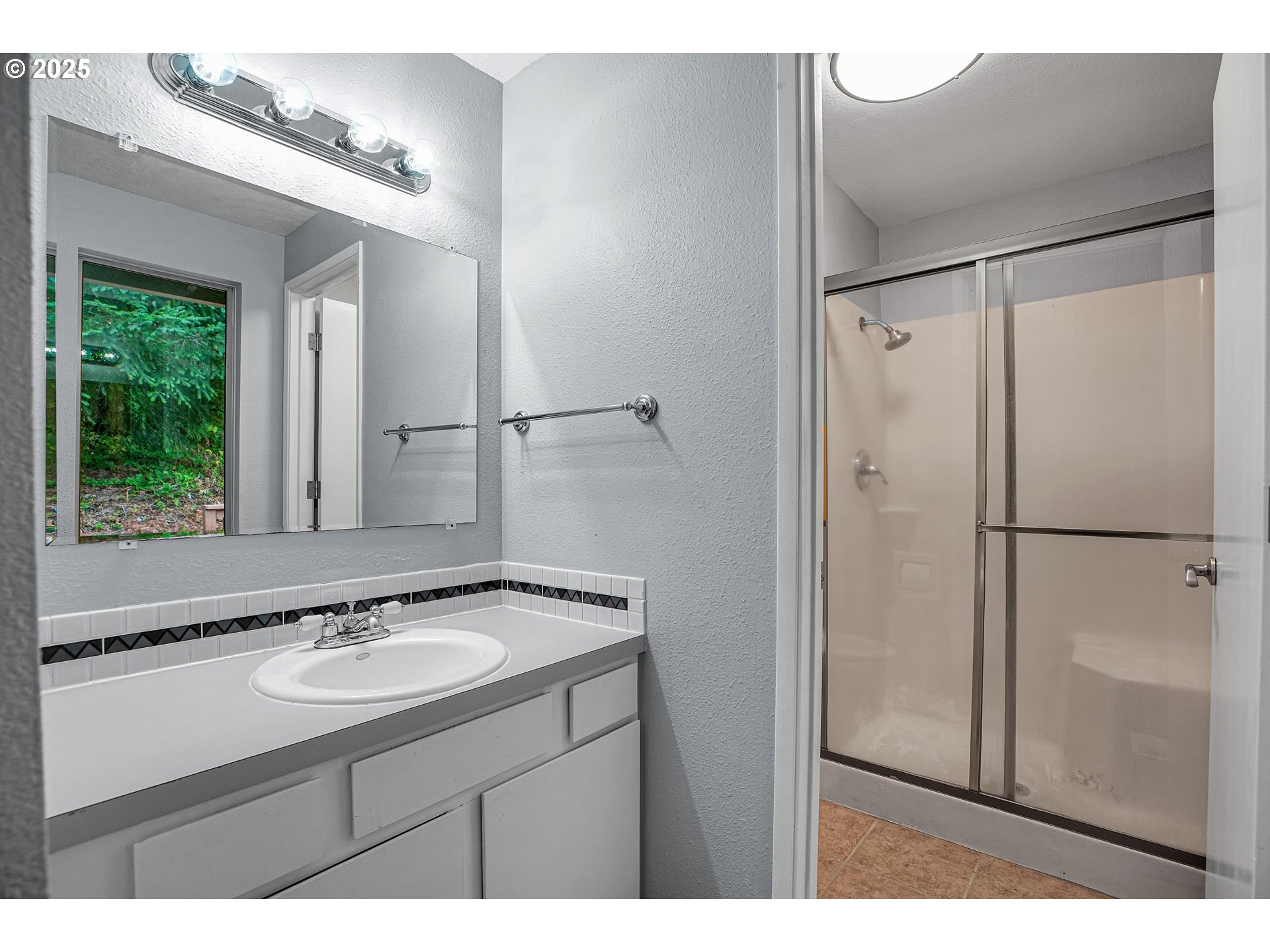 22486 South Redland Road Estacada, OR 97023 - Photo 31 of 46 a bathroom with a sink mirror and a shower