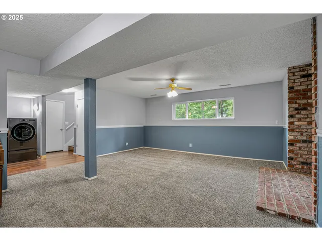 a view of a room with a refrigerator and mirror