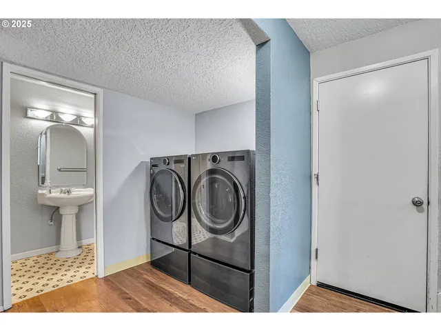 a view of an empty room with a cabinet and window