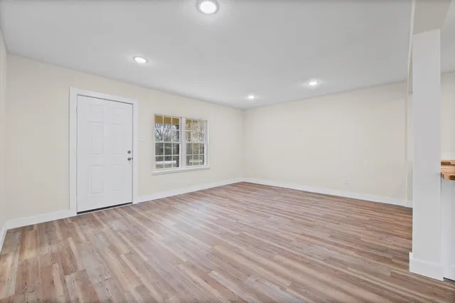 a large kitchen with granite countertop a large counter top and stainless steel appliances