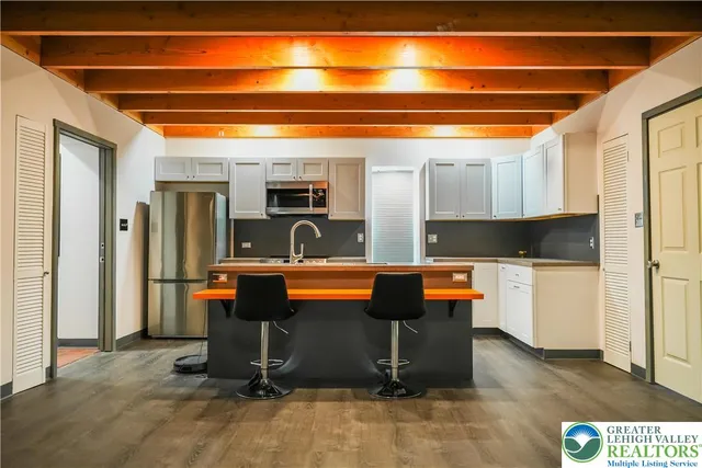 a view of kitchen with furniture and refrigerator