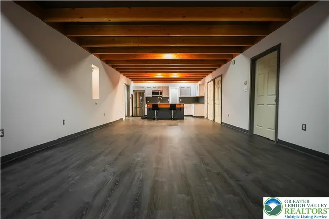 a view of a hallway and a livingroom with furniture