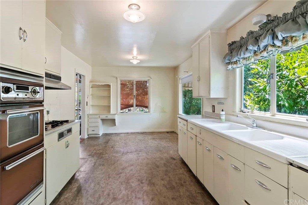 1620 Puebla Drive Glendale, CA 91207 - Photo 12 of 34 a kitchen with a sink stove and refrigerator