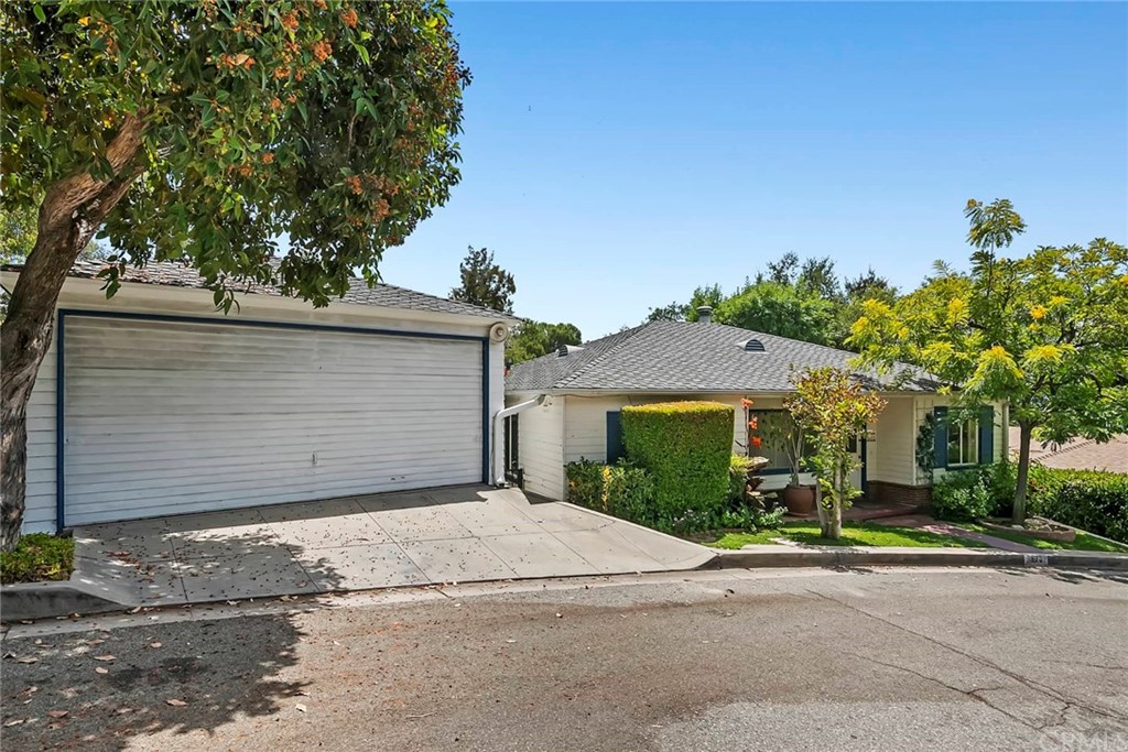 1620 Puebla Drive Glendale, CA 91207 - Photo 3 of 34 a front view of a house with a yard and garage
