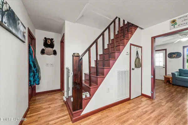 a view of an entryway with wooden floor and stairs
