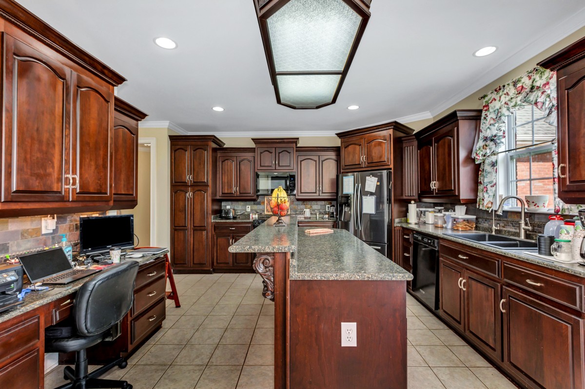7388 Prospect Road Prospect, TN 38477 - Photo 10 of 46 a kitchen with stainless steel appliances granite countertop a refrigerator a sink dishwasher a stove and a dining table with wooden floor