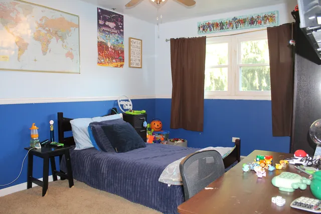 a bedroom with a bed and a window