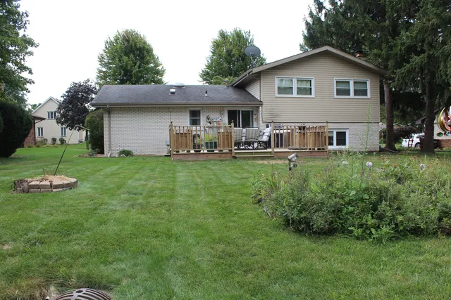 a view of a house with a yard and sitting area