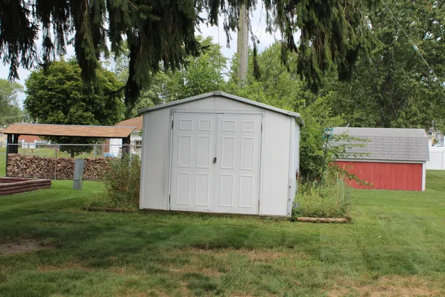 a view of backyard of house with green space