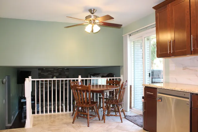 a dining room with furniture a chandelier and wooden floor
