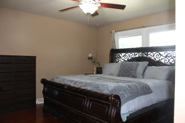 a bedroom with a bed and a dresser