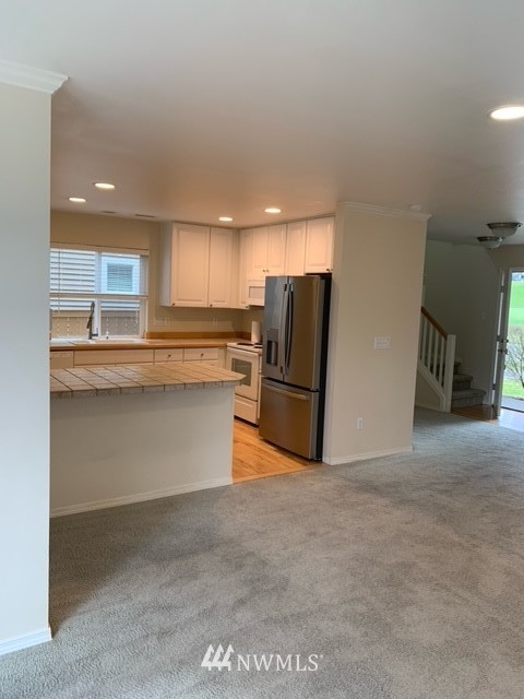 35215 Southeast Ridge Street Snoqualmie, WA 98065 - Photo 5 of 25 a kitchen with stainless steel appliances granite countertop a refrigerator and a stove