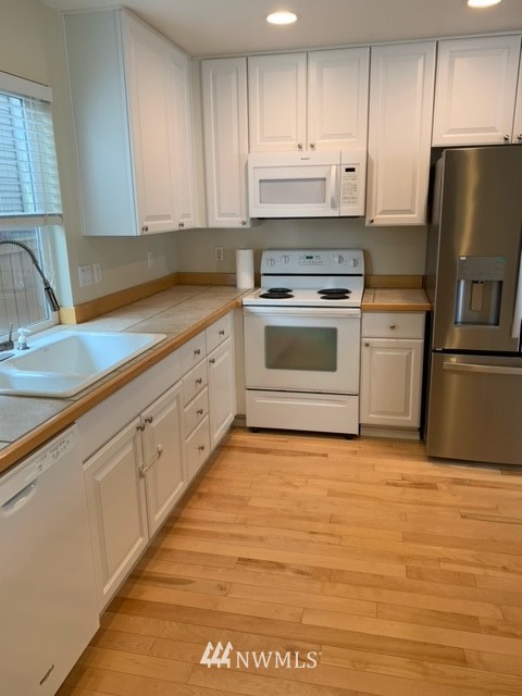35215 Southeast Ridge Street Snoqualmie, WA 98065 - Photo 7 of 25 a kitchen with stainless steel appliances granite countertop a stove a sink and a refrigerator
