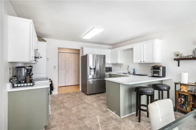 a kitchen with a refrigerator stove top oven and sink