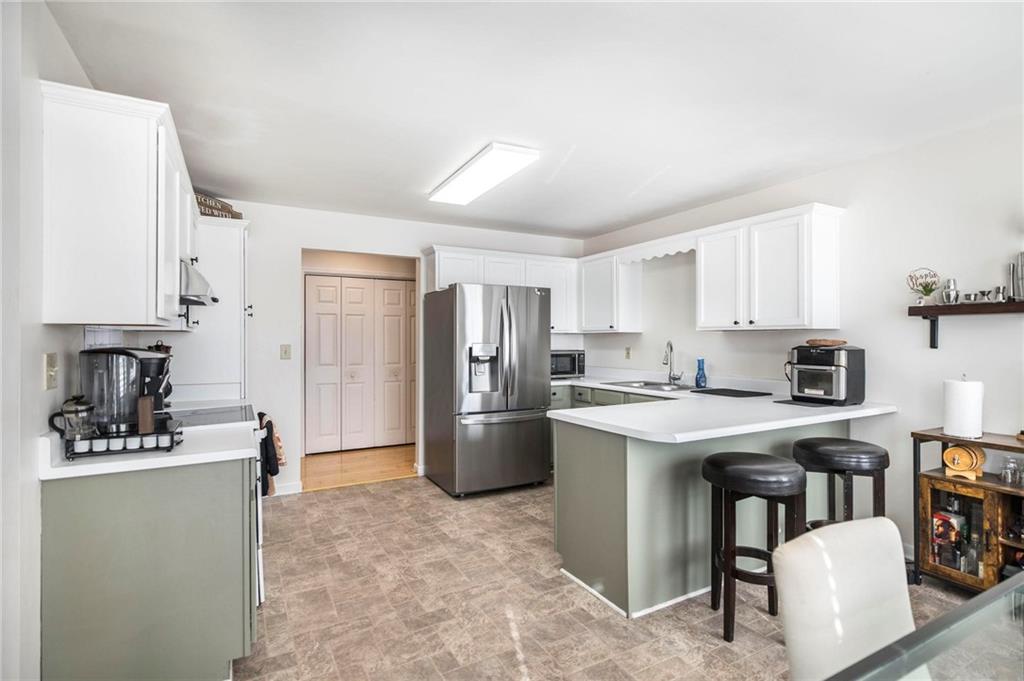 306 Jason Court Macon, GA 31216 - Photo 11 of 30 a kitchen with a refrigerator stove top oven and sink