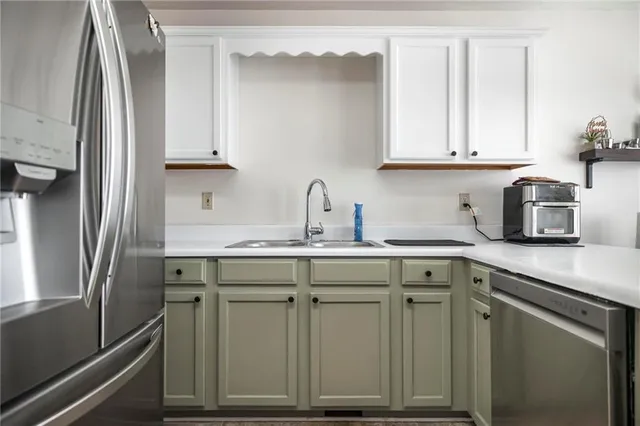 a kitchen with cabinets appliances and a sink