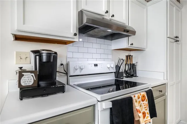 a kitchen with a stove and a refrigerator