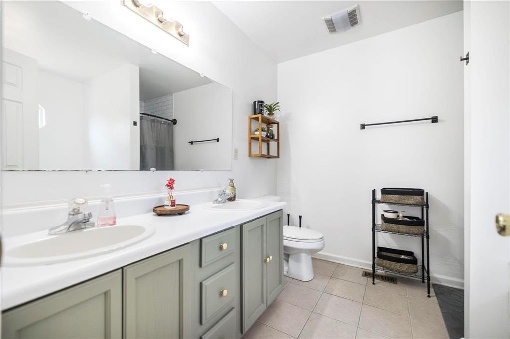 306 Jason Court Macon, GA 31216 - Photo 18 of 30 a bathroom with a toilet sink and mirror