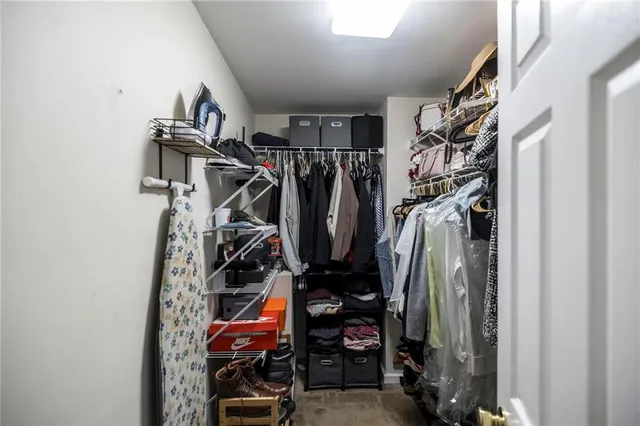a view of walk in closet with clothes