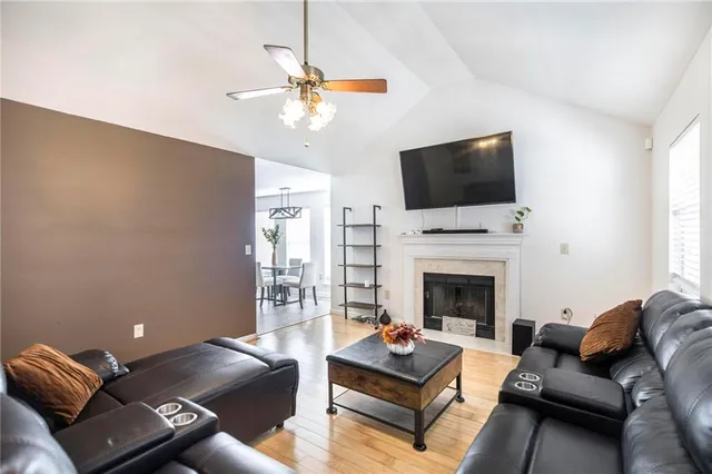 a living room with furniture a fireplace and a flat screen tv