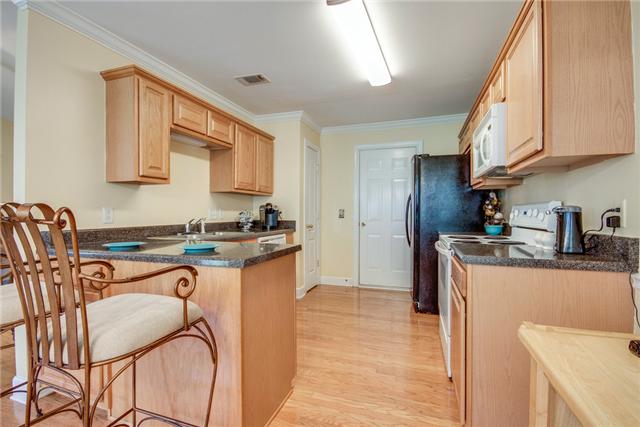 1920 Portway Road Spring Hill, TN 37174 - Photo 2 of 10 a kitchen with stainless steel appliances granite countertop a stove a sink dishwasher and a refrigerator with wooden cabinets