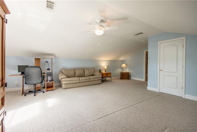 1920 Portway Road Spring Hill, TN 37174 - Photo 8 of 10 a living room with furniture and a chandelier