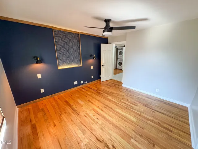 a big room with wooden floor and windows