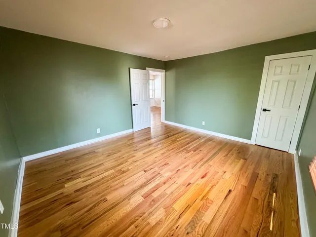a view of a room with wooden floor