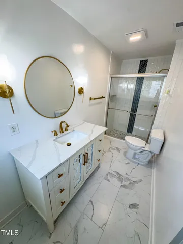 a bathroom with a double vanity sink mirror and