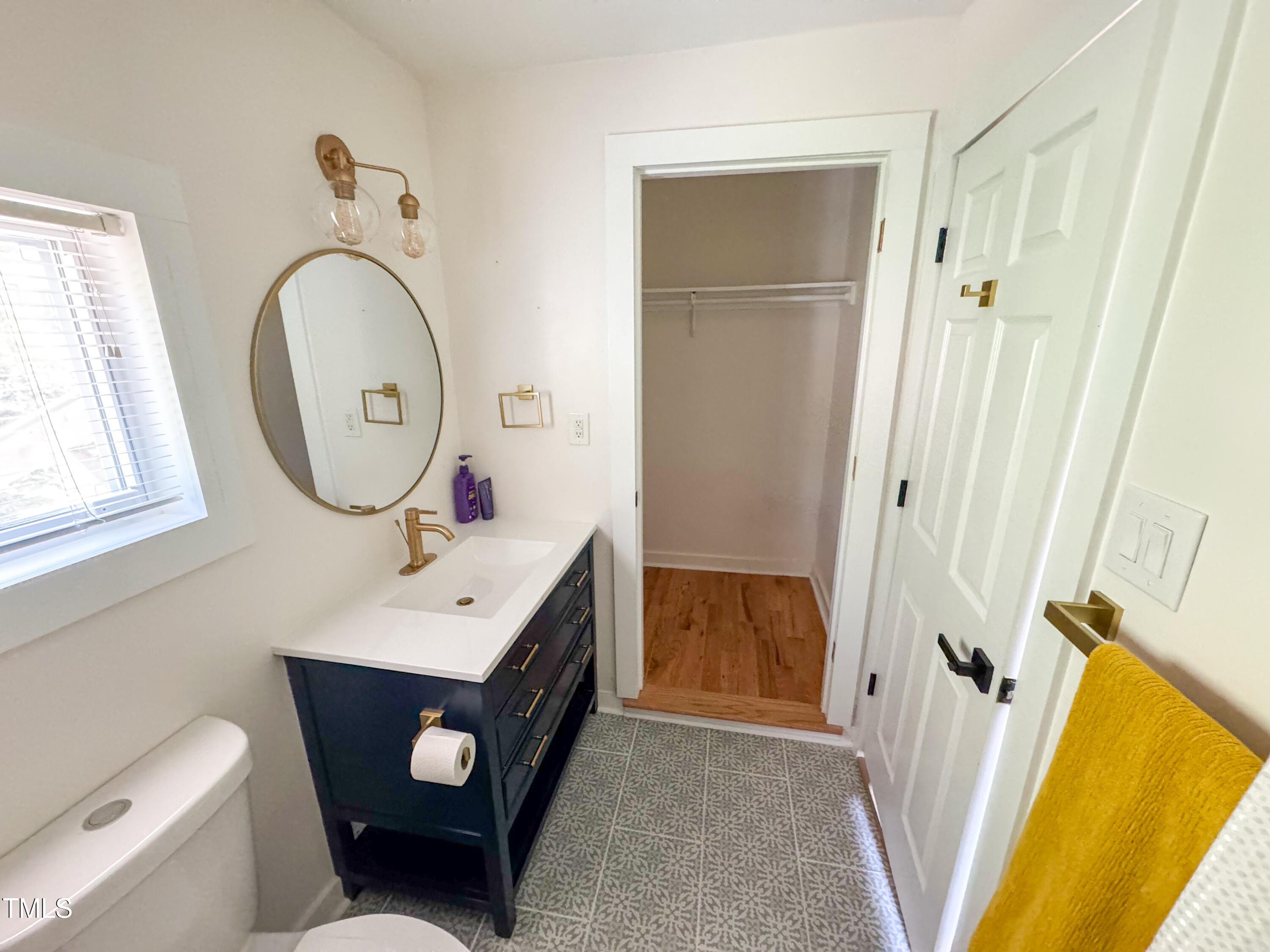 1100 Chester Street Durham, NC 27701 - Photo 24 of 29 a bathroom with a toilet sink vanity tub and mirror