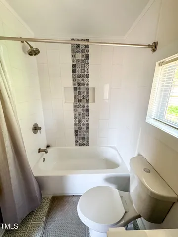 a bathroom with a bathtub and shower