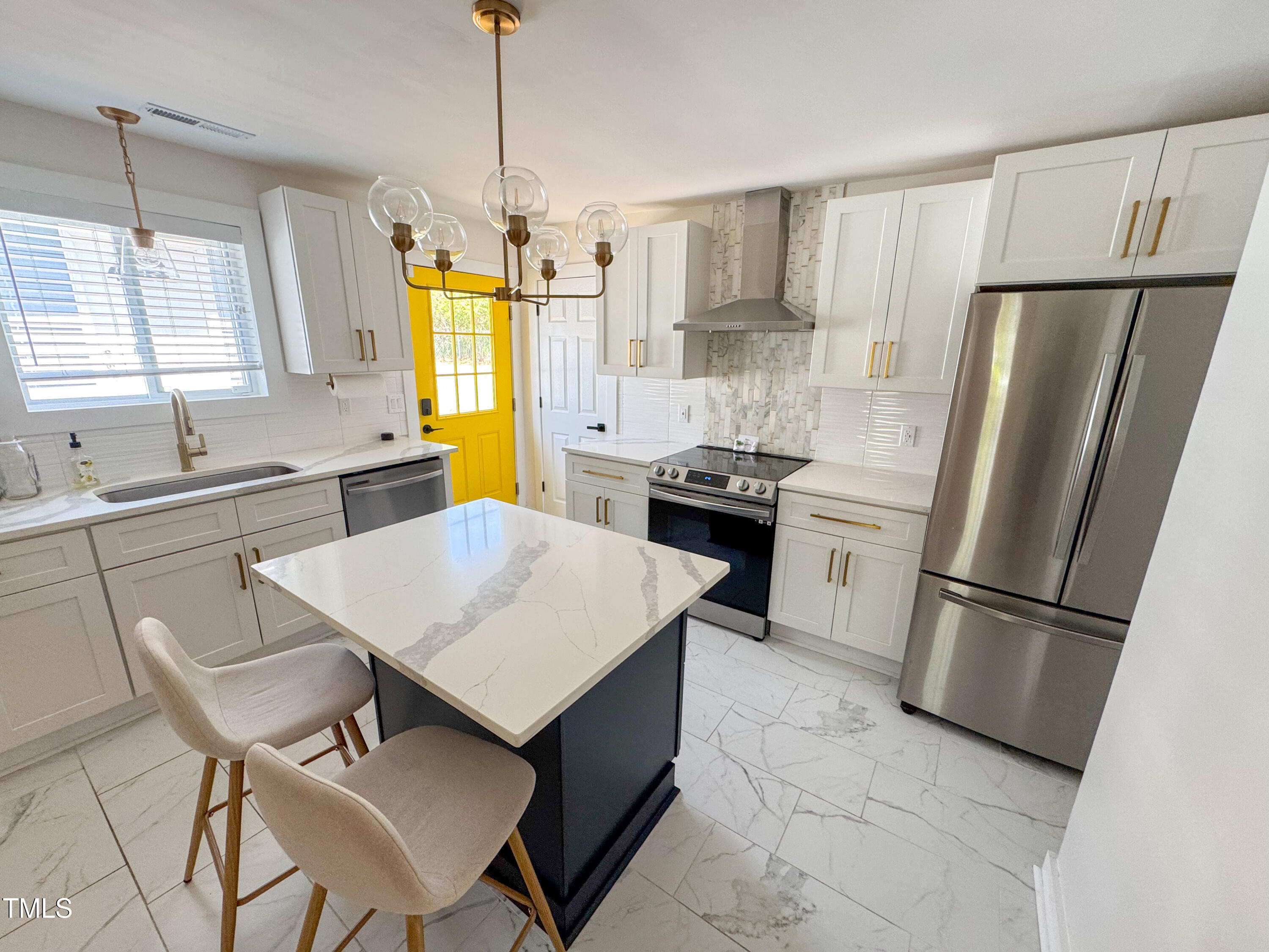 1100 Chester Street Durham, NC 27701 - Photo 10 of 29 a kitchen with stainless steel appliances a refrigerator a sink a stove a table and chairs
