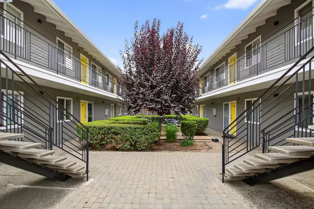 a front view of a multi story building with yard